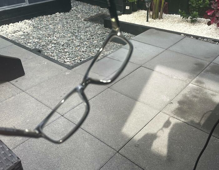 Interesting and cool photos of glasses casting a shadow on a stone tiled patio