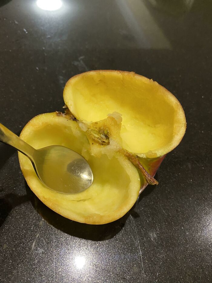An apple hollowed out with a spoon, showing husbands funniest quirks.