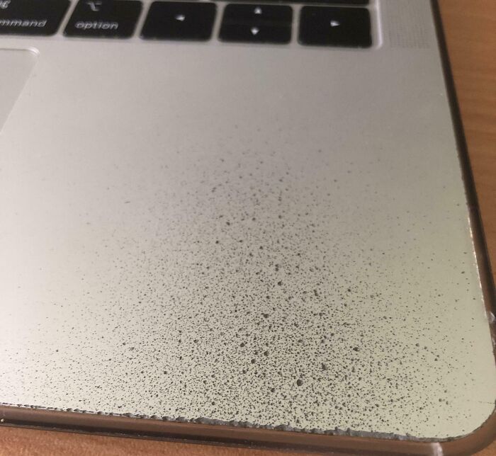 Cool photo of a laptop palm rest worn down to the aluminum after years of use