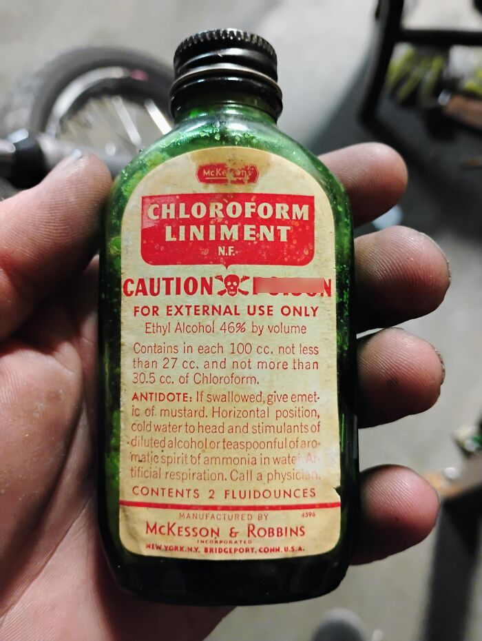 A hand holding an old bottle of chloroform liniment showing how medicine has changed
