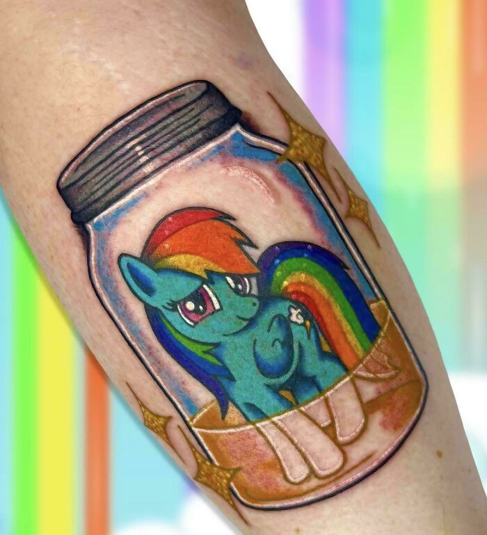 A colorful tattoo of Rainbow Dash inside a glass mason jar, showcasing well-made creations.