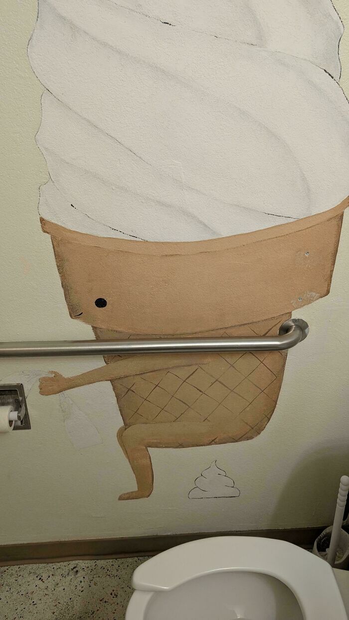 A bathroom wall painting depicting an ice cream cone sitting on a toilet, among awful creations in art.
