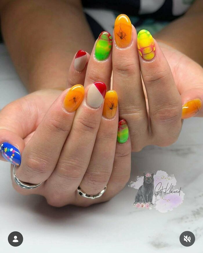 Manicured fingernails decorated with realistic mosquito nail art, representing awful creations in beauty.