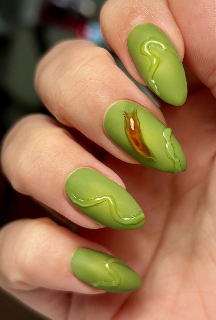 Green manicure featuring 3D slug and slime nail art designs.