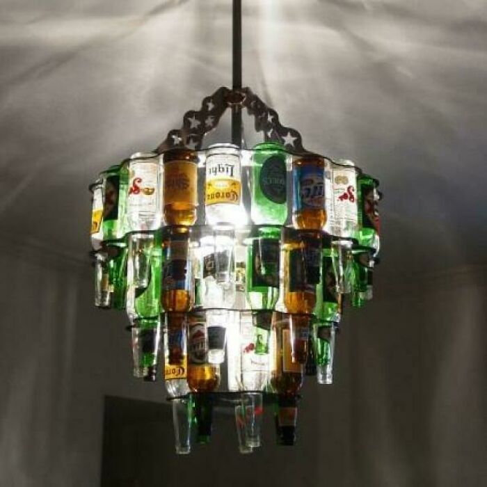 A multi-tiered chandelier made from recycled beer bottles as awful creations.