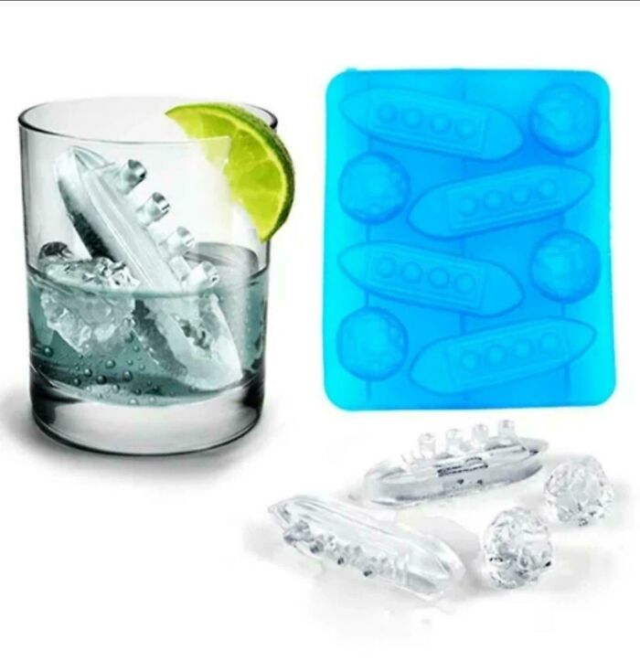 A drink with boat-shaped ice cubes next to a silicone mold as well-made creations.