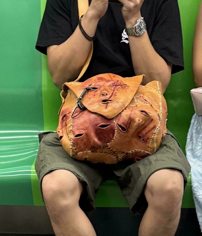 A leather bag stitched together to look like multiple human faces, one of many well made awful creations.