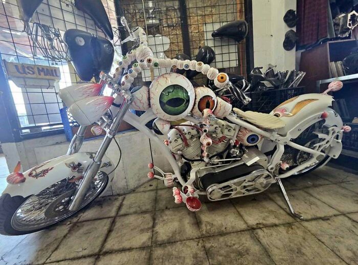 A custom motorcycle covered in realistic eyeball decorations as well-made creations.