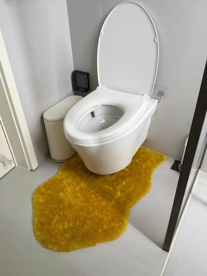 A white toilet sitting over a yellow fuzzy rug, showcasing unique creations and awful e*******n.