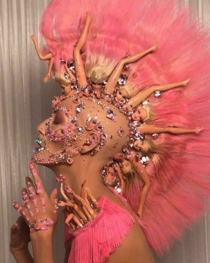 Extravagant pink makeup look featuring doll limbs, one of many creations awful to look at but well-made.