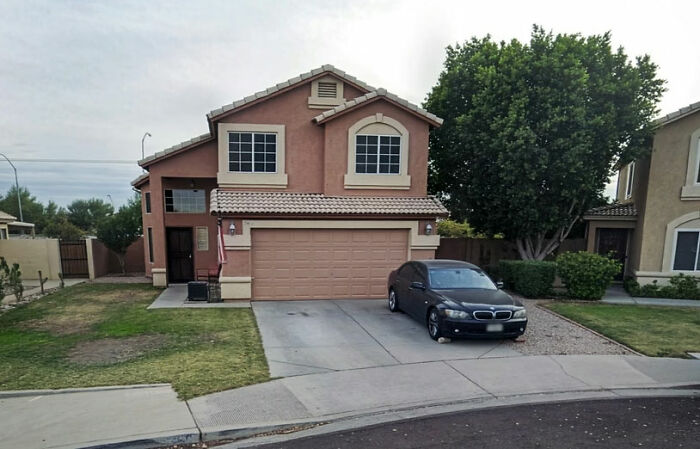 Exterior of the $450K home seized and sold by HOA over less than $1K debt, with a black car in driveway
