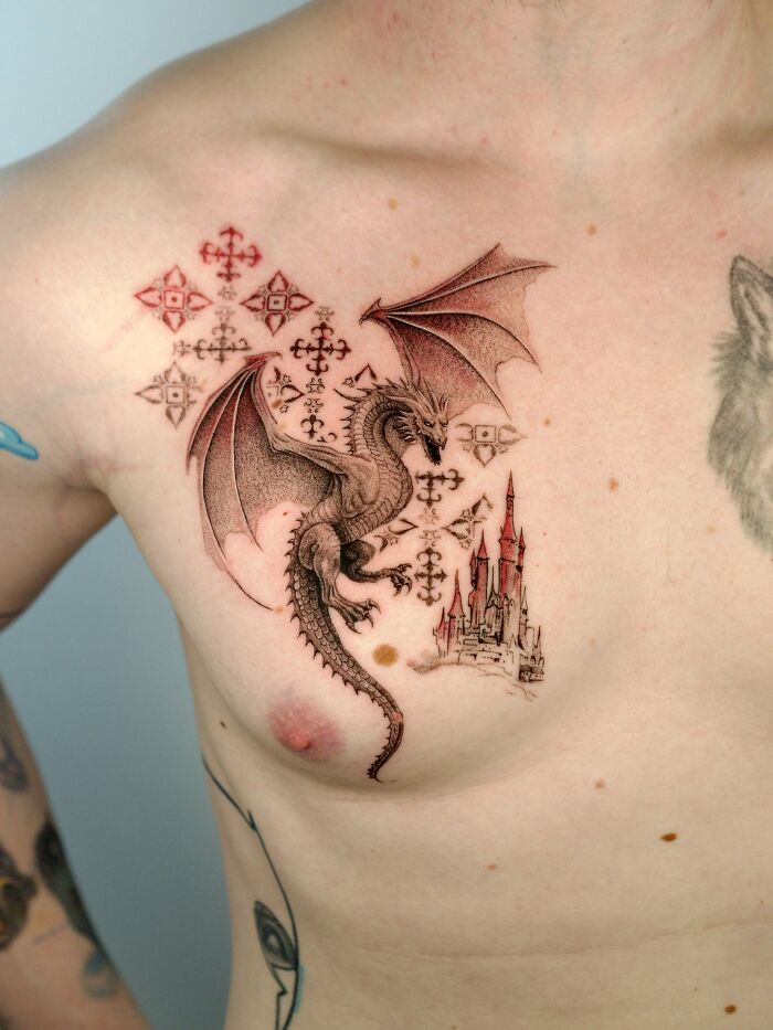 Dragon and castle tattoo in nature ink on chest