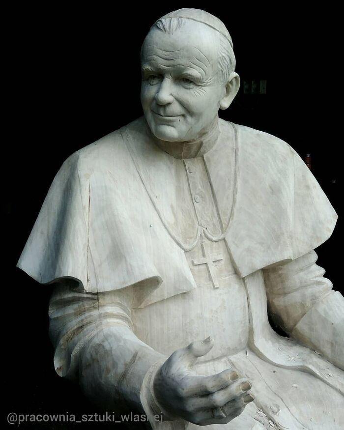 A detailed wood sculpture of Pope John Paul II hand-carved by a Polish artist