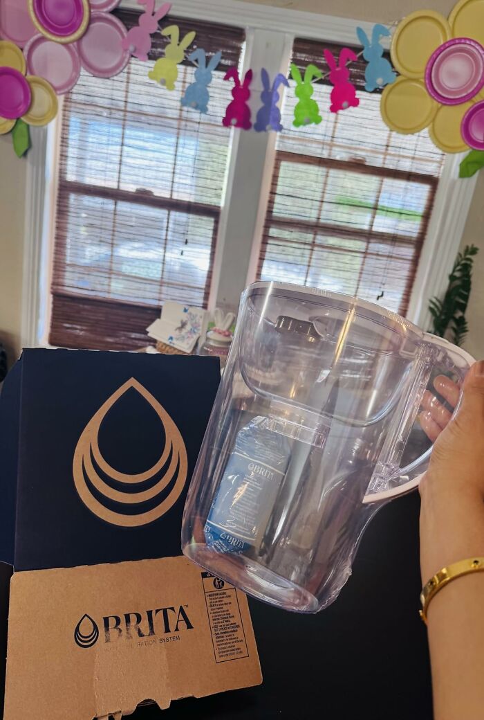 A clear Brita water filter pitcher held in front of its box, a great find from Prime Big Deal Days