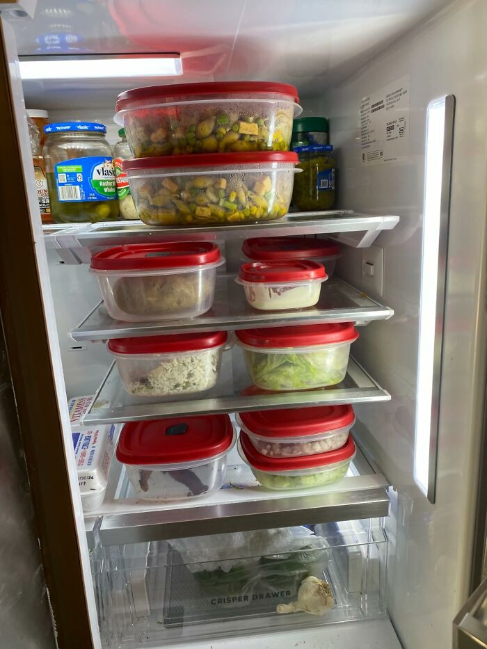 Stack of organized food containers in a fridge, great for Prime Big Deal Days prep.