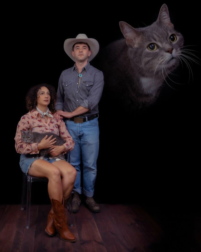 A silly portrait of pets and their owners featuring a couple in cowboy attire holding a grey cat, with a large cat head floating above them.