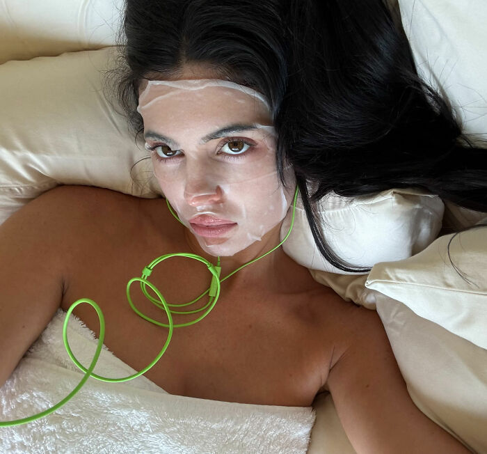Woman with a facial mask and device, contrasting with Japanese women and Western beauty standards. Woman with a facial mask and device, contrasting with Japanese women and Western beauty standards.