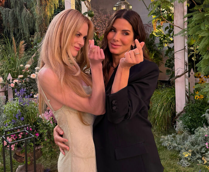 Iconic actresses, Nicole Kidman and Sandra Bullock, posing together with forever-young looks, making heart gestures. Iconic actresses, Nicole Kidman and Sandra Bullock, posing together with forever-young looks, making heart gestures.
