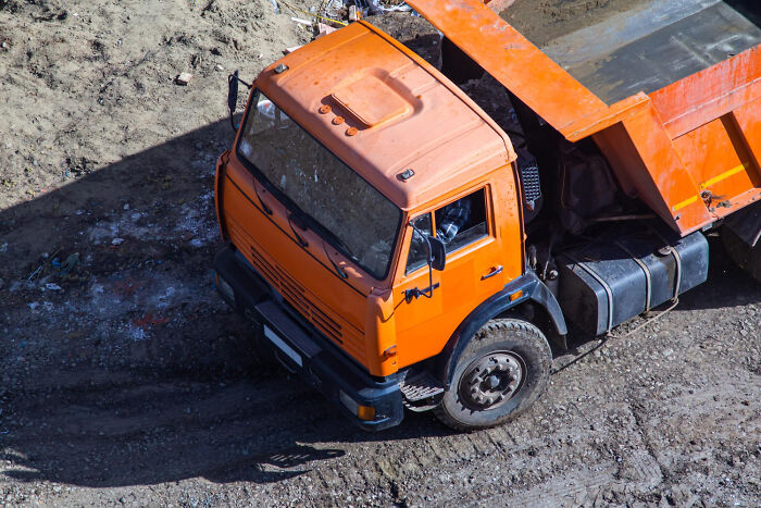 An orange dump truck, symbolizing messy arguments often heard in court.
