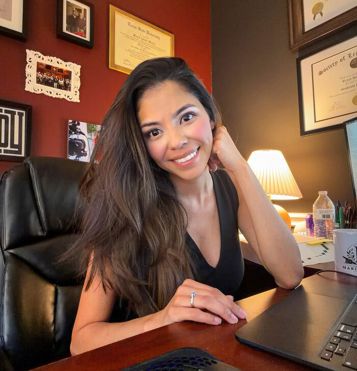 A female lawyer smiling in her office, representing the female colleagues topic.
