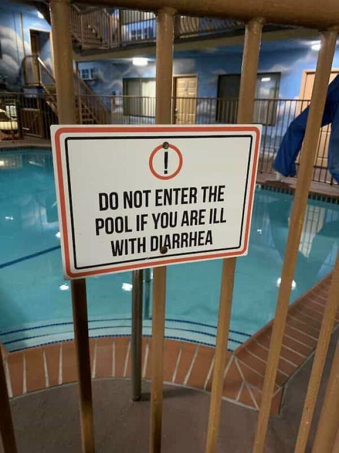 A funny sign by a swimming pool, warning Do not enter the pool if you are ill with diarrhea.
