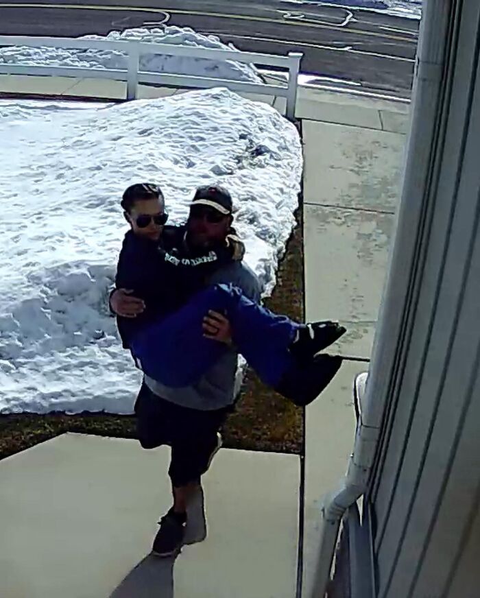 A man carrying a woman through snow, a sweet proof they found the right man.