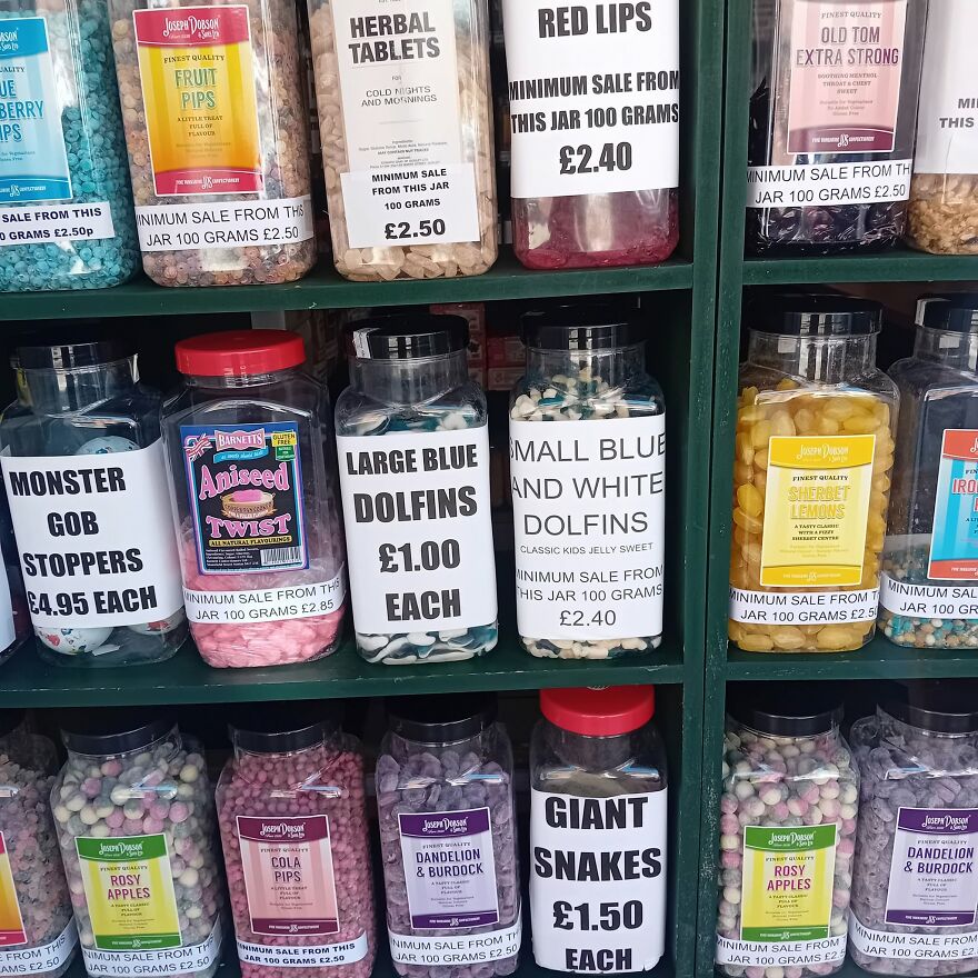 Shelves of candy jars with grammar fails including misspelling of dolphins as dolfins.