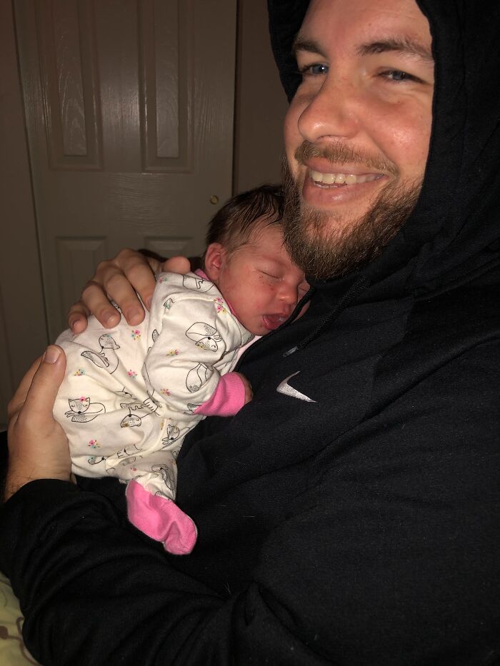 A happy man holding a newborn baby, proof of finding the right man.