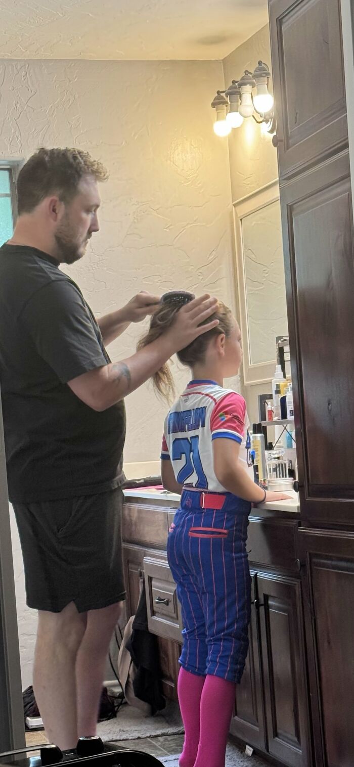 A dad styling his daughter's hair, a sweet everyday moment showing a loving bond and proof of finding the right man.