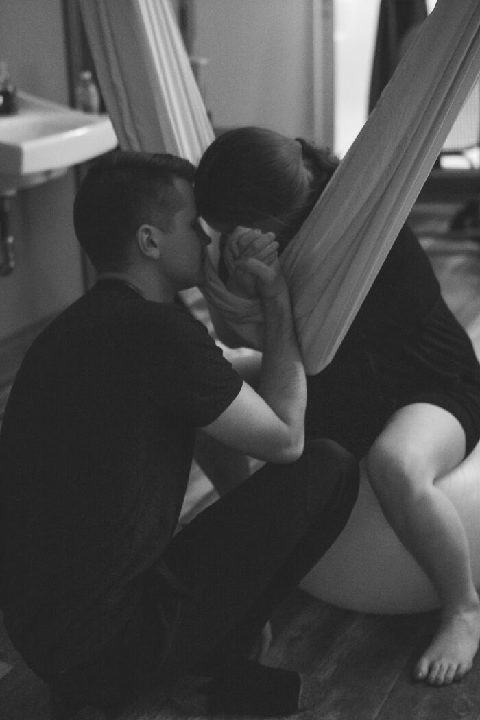 A black and white image of a man comforting a woman during labor, showing proof they found the right man.