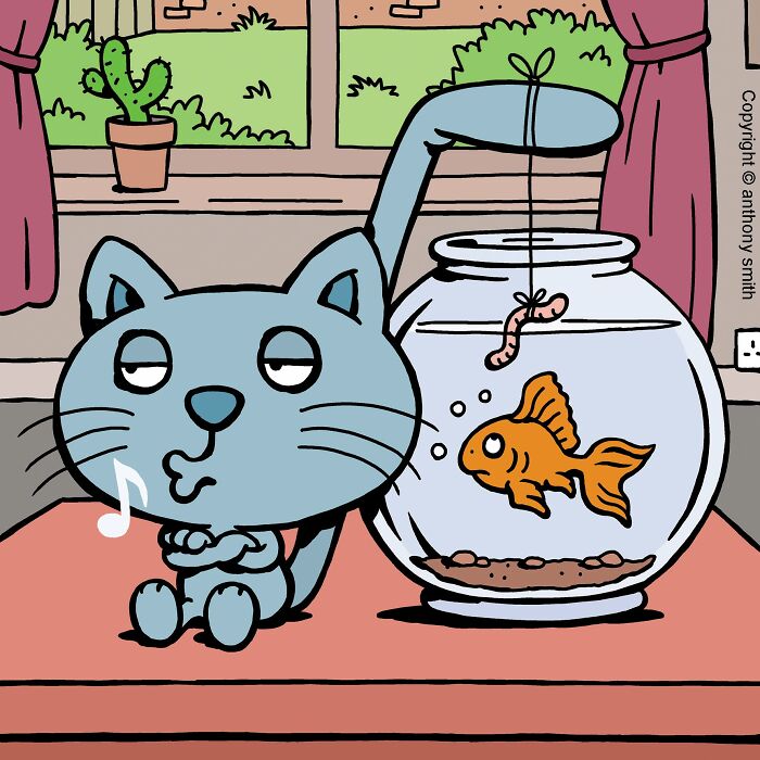 A cat with cattitude playfully dangles a worm above a goldfish in a bowl, illustrating cat life.