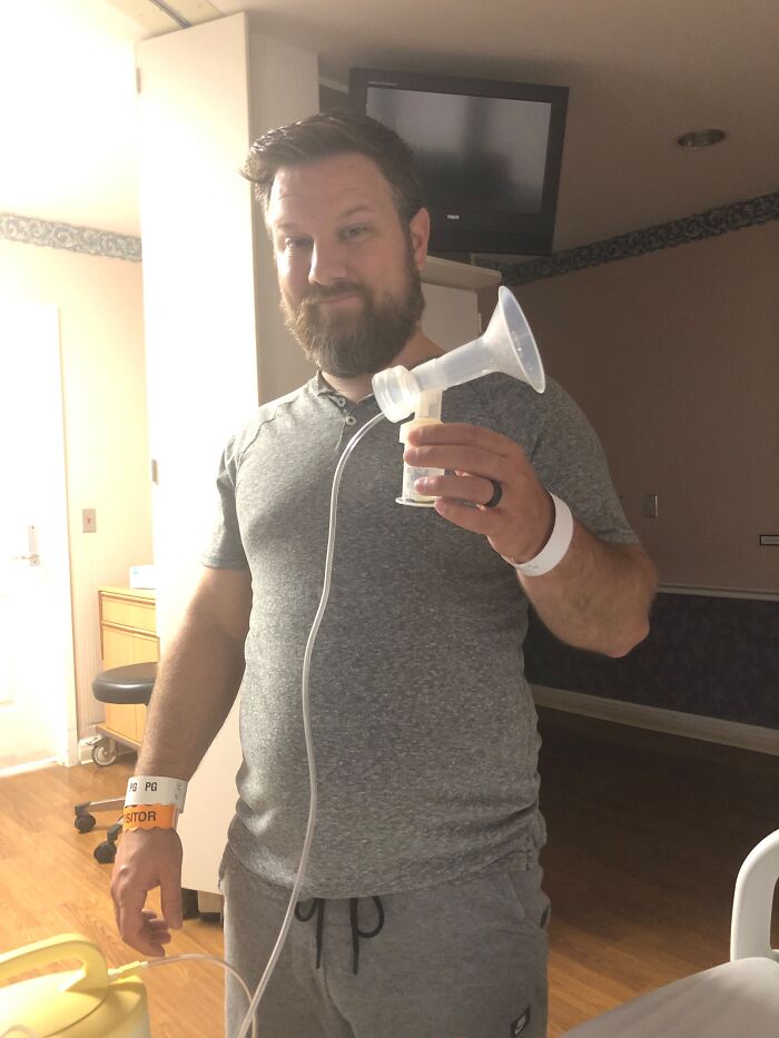 A man holding a breast pump in a hospital room, sweet proof they found the right man.
