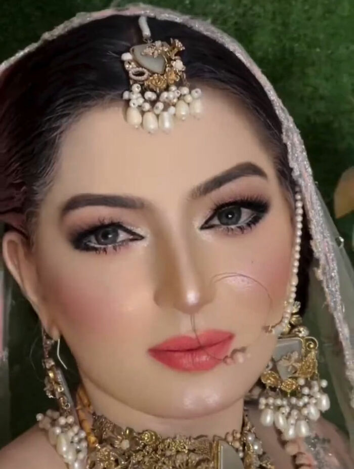 Close-up of a woman's dramatic wedding day transformation, featuring elaborate makeup and traditional jewelry. Close-up of a woman's dramatic wedding day transformation, featuring elaborate makeup and traditional jewelry.