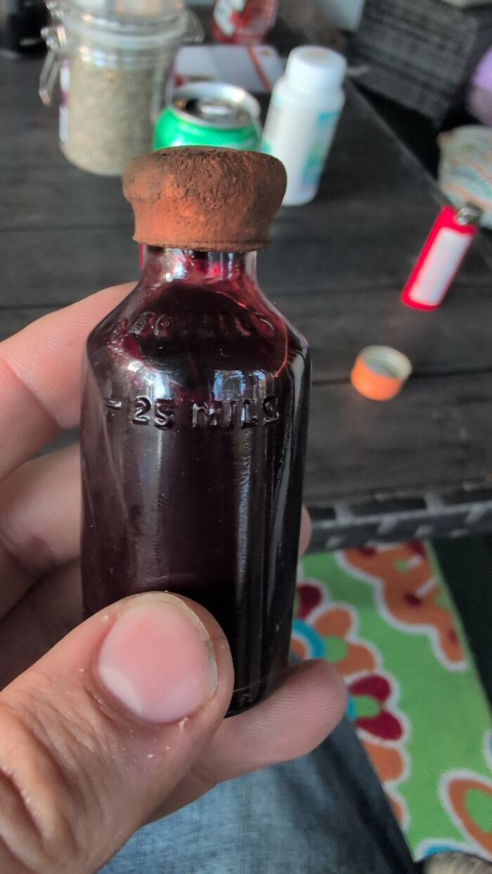 Hand holding a vintage medicine bottle from medical history