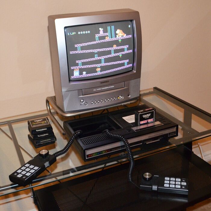 An Atari 5200 retro tech console and joysticks from the '80s, connected to a CRT TV playing Donkey Kong.