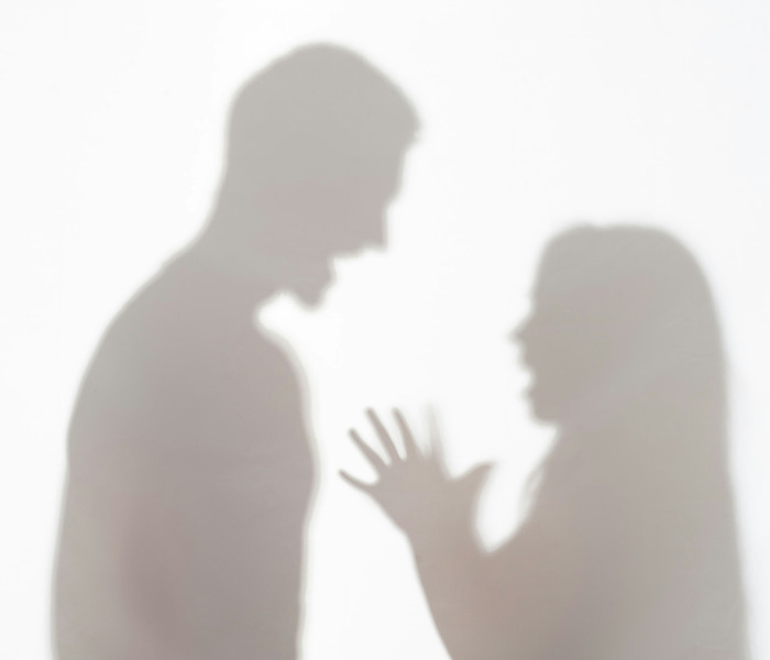 Shadows of a man and woman in a heated argument after she rejected him, raising awareness. Shadows of a man and woman in a heated argument after she rejected him, raising awareness.
