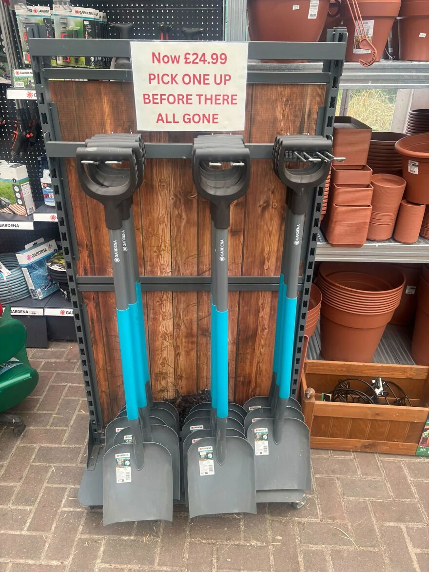 Gardening shovels on display with a sign featuring grammar fails of there instead of they are