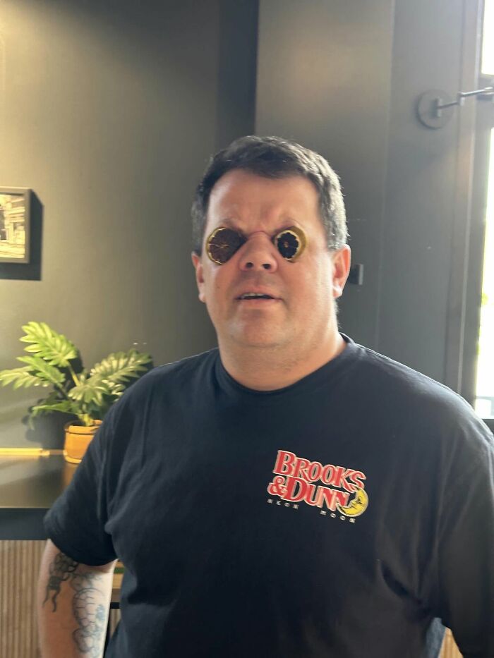 A man with donut holes on his eyes, wearing a black shirt, found the right man.
