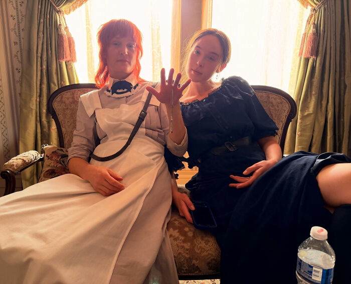 Two actresses from the Lizzie Borden Series posing in period costumes on set Two actresses from the Lizzie Borden Series posing in period costumes on set