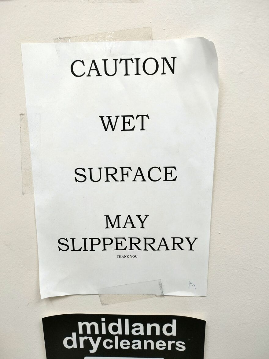 A sign warning of a wet surface with a grammar fail spelling slippery as slipperrary.