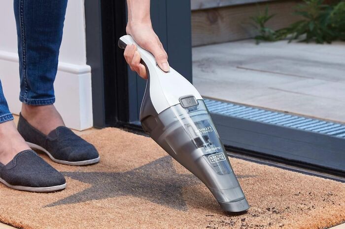 Hand holding a Black and Decker cordless handheld vacuum cleaner, a find from Prime Big Deal Days