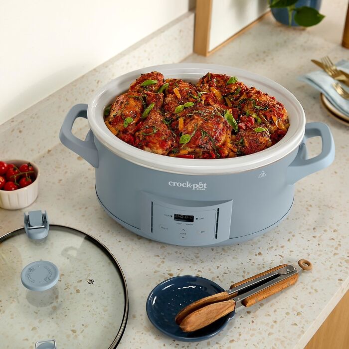 A blue Crock-Pot slow cooker filled with cooked chicken on a kitchen counter, a top pick from Prime Big Deal Days