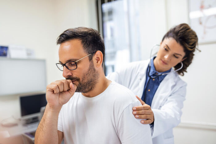 A doctor checking a man who is coughing, possibly a life story ending unexpectedly.