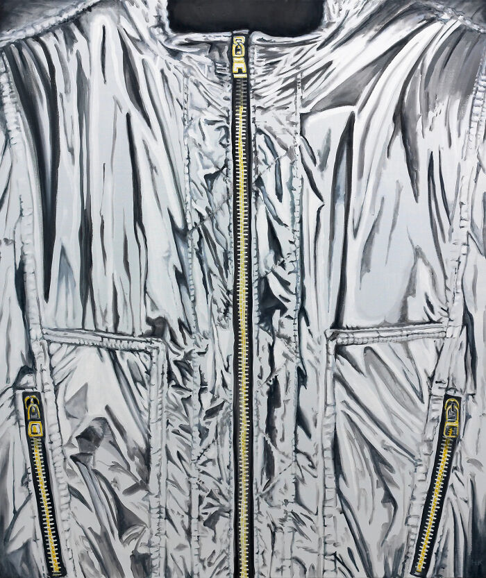 A striking portrait of identity featuring a shiny silver jumper with gold zippers, showcasing unique fabric texture.