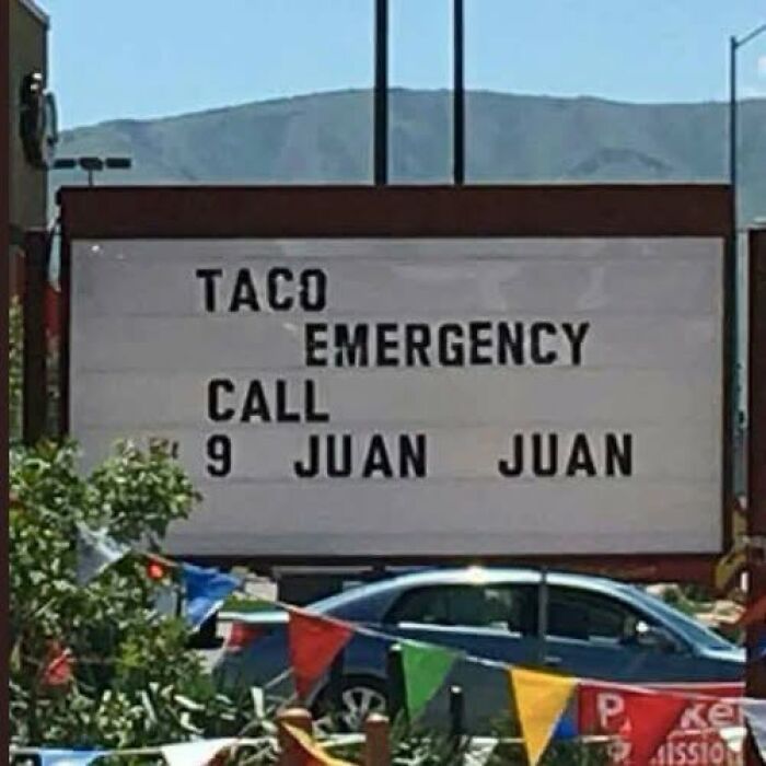 A silly sign advertises Taco Emergency, Call 9 Juan Juan, a pun on 911.