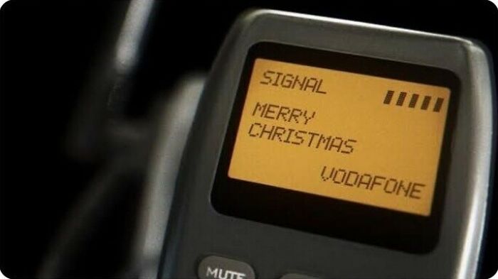 A close-up of an old mobile phone screen displaying a Christmas message, part of the retro tech photos.