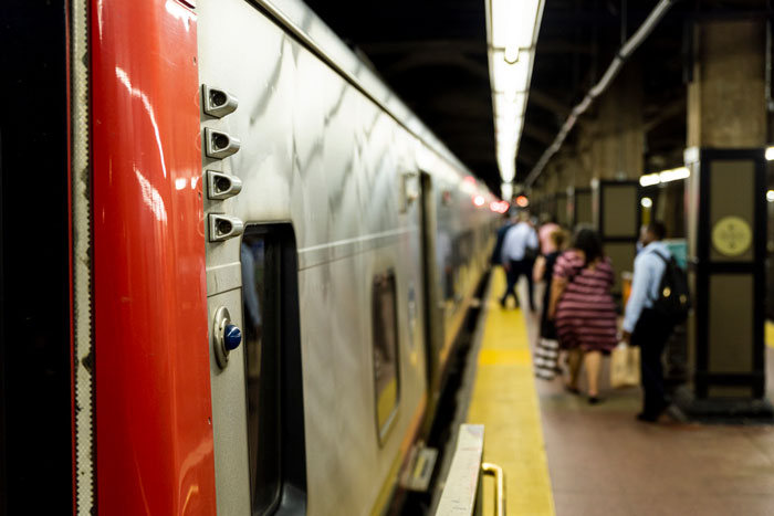 Passengers wait on a platform next to a train, illustrating stories of karma and deserving outcomes.