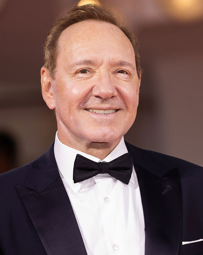 Kevin Spacey in a tuxedo, another famous face linked to Hollywood secrets.