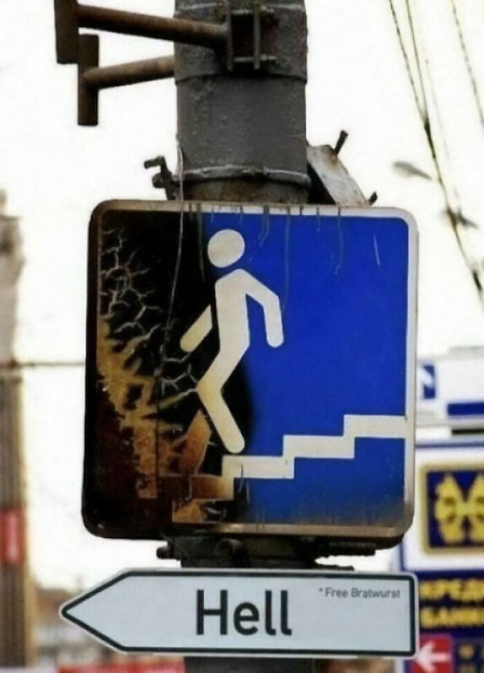A chaotic sign pointing to Hell with *Free Bratwurst, showing a person walking up stairs into a blue light.