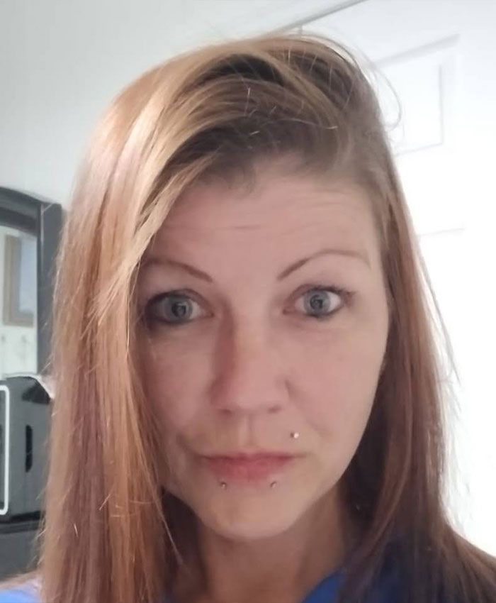 A woman with reddish-brown hair and lip piercings. This mom and son were charged after a damning confession.